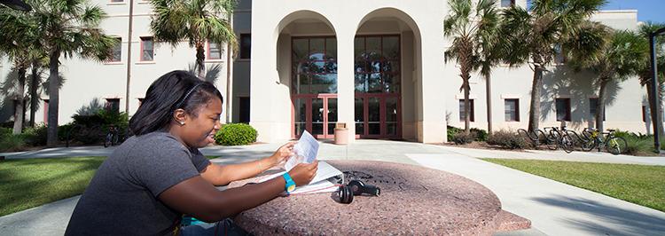 Student studying outside building